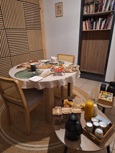 a table with food on it in a living room at Détente Gersoise in Lasserade