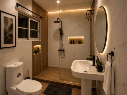 a bathroom with a shower and a toilet and a sink at Palazzo Apartments in Ikeja