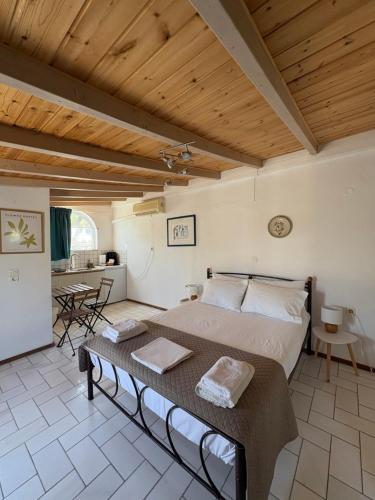 a bedroom with a large bed and a table at Studio Apartments in Monemvasia