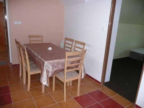 a dining room table with four chairs and a table and a table and chairsktop at Penzion Lipina in Slatiňany