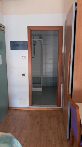 a bathroom with a shower with a glass door at Hotel Diplomatic - Bianchi Hotels in Cesenatico