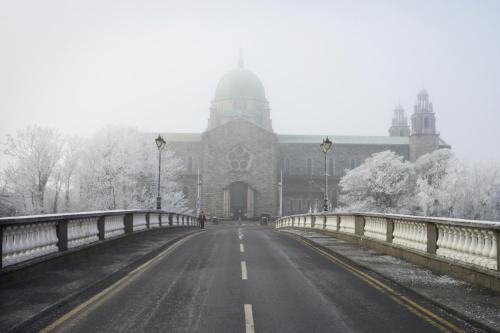 a bridge over a road in front of a building at The Residence Hotel in Galway