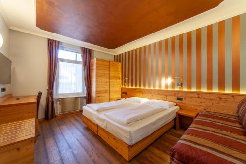 En eller flere senge i et værelse på Hotel Cles