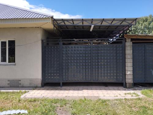 a black gate in front of a house at Aziz House in Naryn