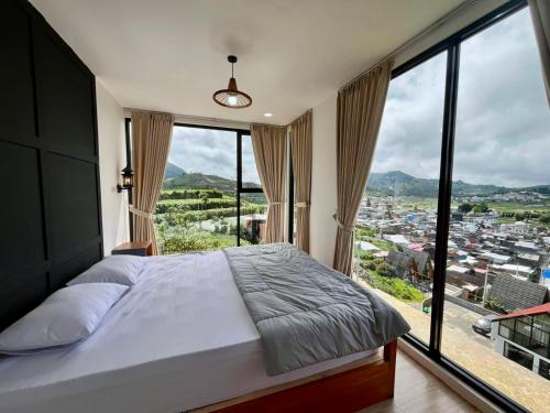 a bedroom with a bed and a large window at Oemah Ntuy Full view in Diyeng