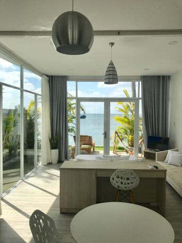 a living room with a view of the ocean at TS Beach House in Phu Quoc