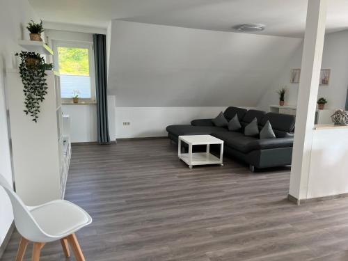 a living room with a couch and a table at Ferienwohnung Schöpf - Fränkische Schweiz in Obertrubach