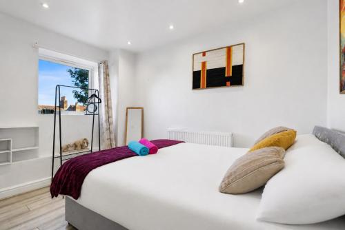 a bedroom with a white bed and a window at K Suites - Nuxley Road in Bexley