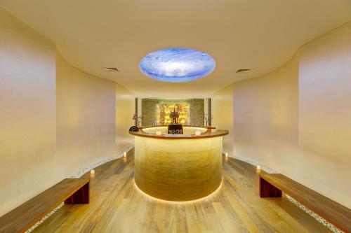 a large room with a bar with a blue ceiling at Antmare Hotel in Alacati