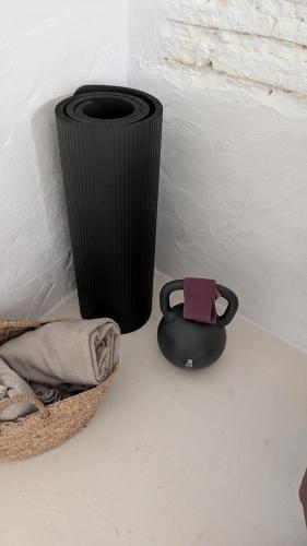 a black trash can next to a basket with a pink tag at Casas Velhinhas - Apartº Aconchego e Apartº Calmaria in Estremoz