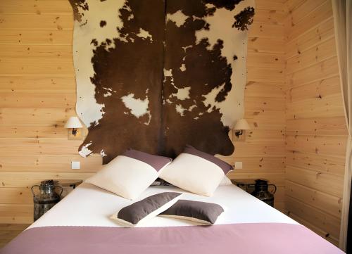 a bedroom with a bed with a wooden wall at Les Bruchels in Longechaux