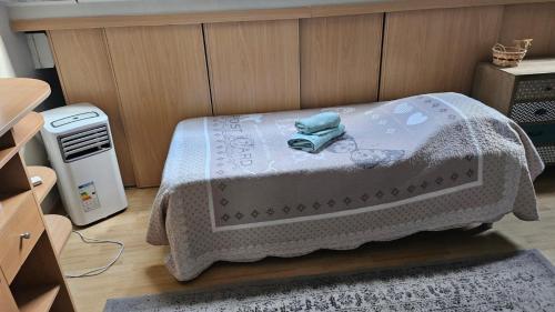 a bedroom with a bed with a blanket on it at L'étoile du matin in Terville