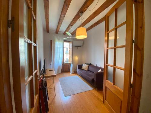 a living room with a couch and a window at Calle Villarroel Barcelona 3-2 in Barcelona