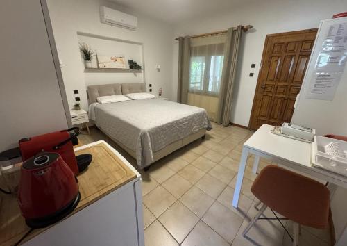 a kitchen and a bedroom with a bed in a room at Garden Guest Room in Fanari