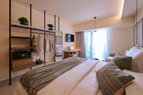 a bedroom with a large bed in a room at Zeus Piraeus Grand in Piraeus