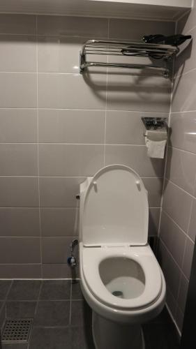 a bathroom with a white toilet in a stall at Zzzip Guesthouse in Hongdae in Seoul