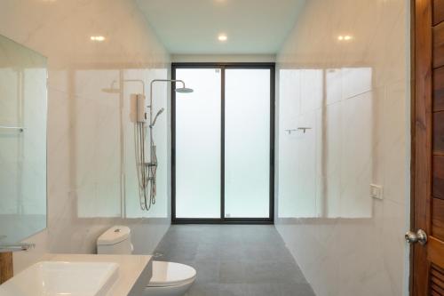 a bathroom with a toilet and a sink and a shower at Neon Villa in Ko Phangan