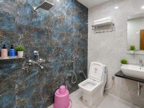 a bathroom with a white toilet and a sink at Vijay Villa in Faizābād