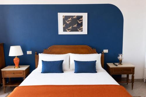 a blue bedroom with a large bed with blue walls at Casa Bottega in San Salvo