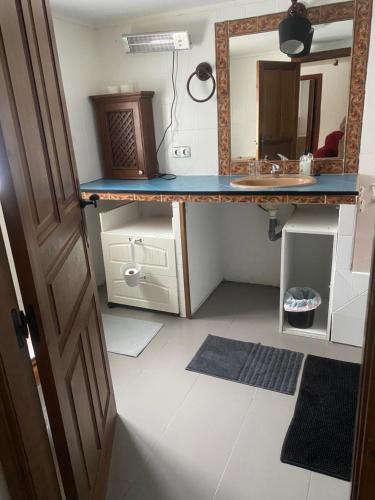 a bathroom with a vanity with a mirror and a sink at El Doblao del Rey in Torrejón del Rey