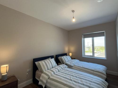 a bedroom with a bed and a window at Ballyconneely Lodge in Ballyconneely