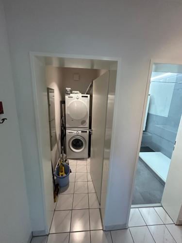 a small bathroom with a washer and dryer at Apartment Grenzland in Herzogenrath