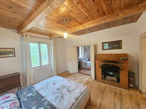 a bedroom with a bed and a fireplace at Leśna Kraina in Międzyrzec Podlaski
