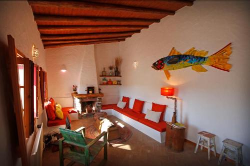 a living room with a fish on the wall at Casa Palheiro, Aldeia da Pedralva in Vila do Bispo