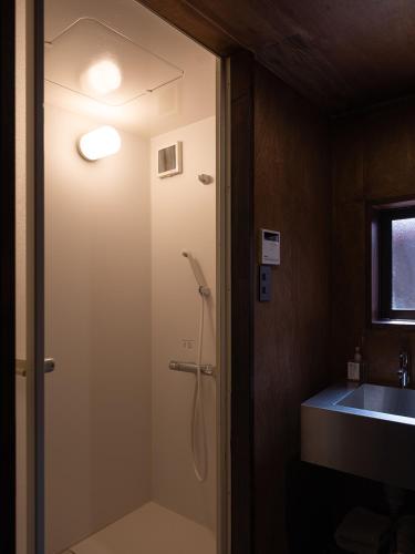 a bathroom with a shower and a sink at 刷々 sassa in Osaka