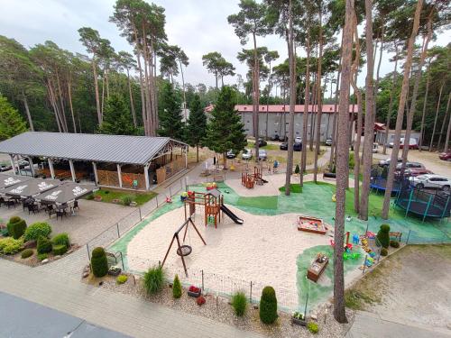 a playground in a park with a play area at Marena Wellness & Spa in Międzywodzie