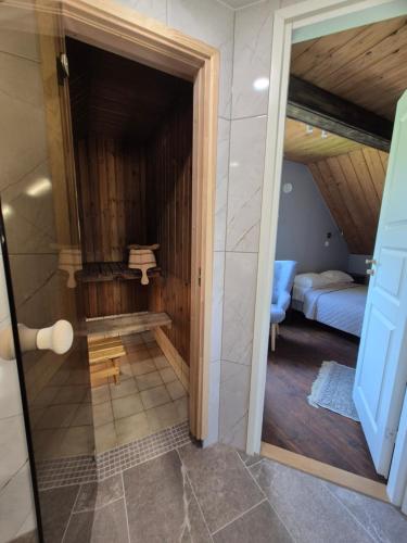 a view of a bathroom with a room with a bed at Kütioru puhkekeskus in Koloreino