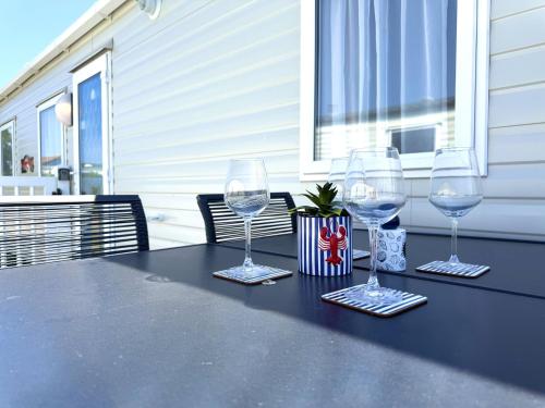 three wine glasses sitting on a table on a patio at Gordy's Nook in Scarborough