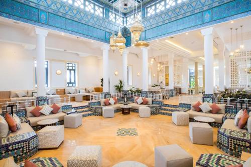 a large lobby with couches and tables in a building at SOL by Meliá Oasis Marrakech - All Inclusive in Marrakesh