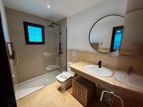 a bathroom with a toilet and a sink and a mirror at VILLA EILA in Playa Blanca