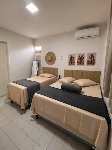 a room with two beds in a room at Recanto da Caatinga in Piranhas