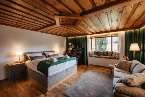 a bedroom with a bed and a desk and a couch at Urlaub am Schafhof in Rimbach