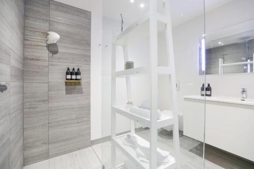 a bathroom with a glass shower and a sink at Vilcon Hotel & Konferencegaard in Slagelse
