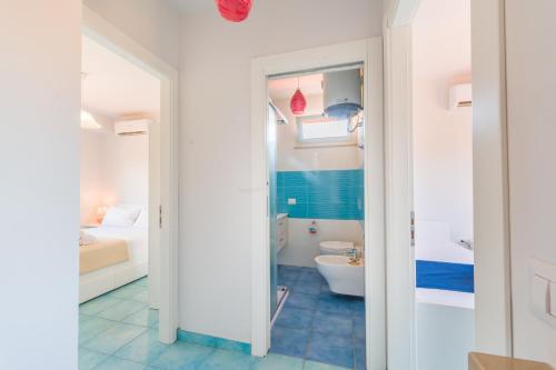 a bathroom with a tub and a toilet in a room at CalaDune Villas in Pizzo
