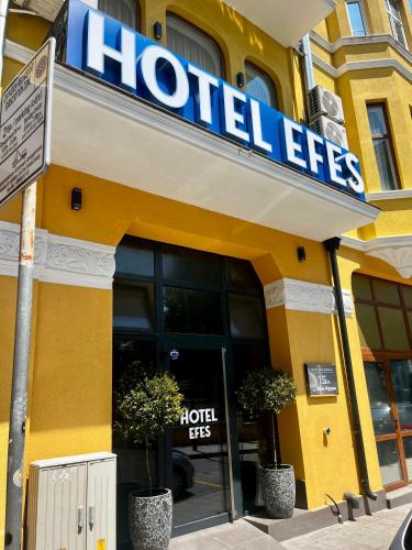 a hotel exit sign in front of a building at Хотел EFES in Burgas