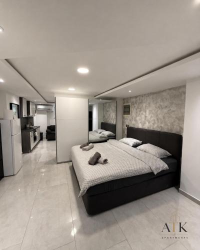 a large bedroom with a large bed and a kitchen at ATK apartment in Koper