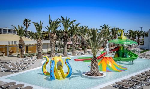 a pool with a water slide in a resort at SOL by Meliá Marina Beach Crete in Gouves