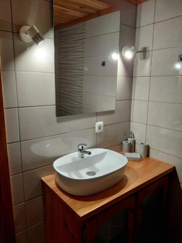 a bathroom with a sink and a mirror at Casa do Bernardo in Feiteira