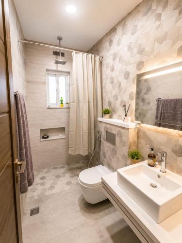 a bathroom with a toilet and a sink at Villa Islamabad Central Hill View Park View in Islamabad