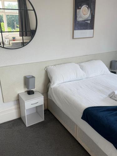 a bedroom with a bed and a mirror on the wall at The Rising Sun in Rogerstone