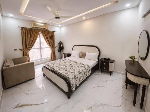 a bedroom with a bed and a chair and a piano at Villa Islamabad Central Hill View Park View in Islamabad