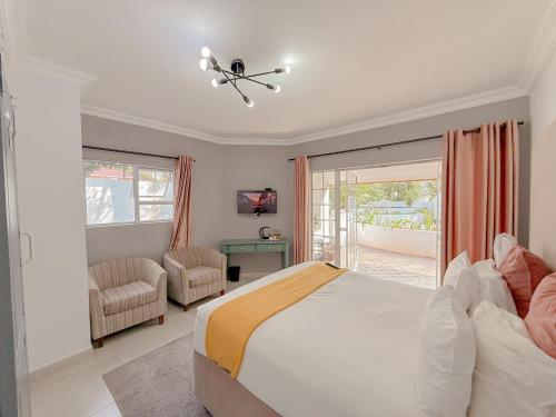 a bedroom with a large bed and a balcony at Amoris on Anderson in Pretoria