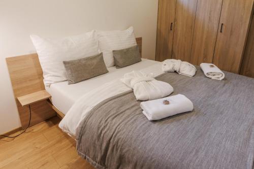 a bedroom with a bed with two towels on it at ARIETES MARMONT Apartmány in Tatranska Strba