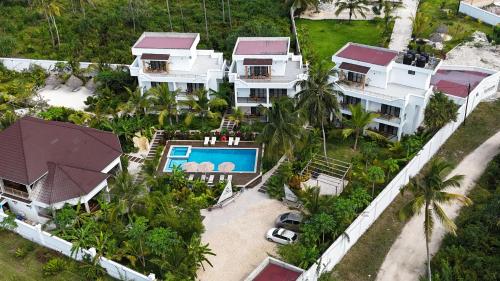 an aerial view of a house with a swimming pool at Changarawe Hotel & Retreat in Pongwe
