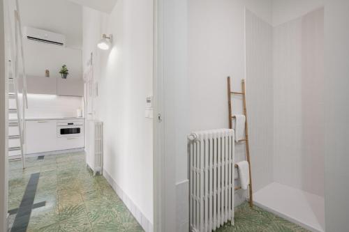 a kitchen with white walls and a radiator at Raízes 22 - Apartamento 5 in Puebla de Don Fadrique