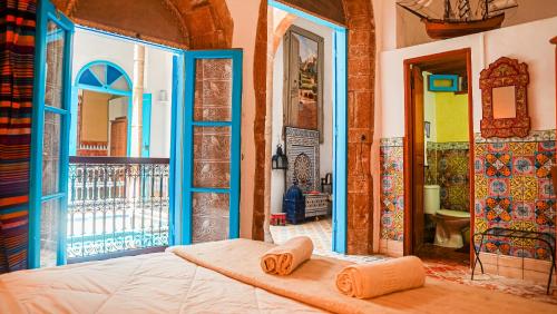 a bedroom with a bed with two towels on it at Riad Le Cheval Blanc in Safi